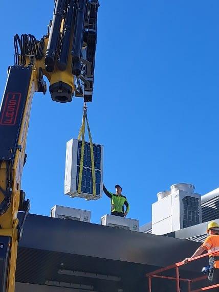 Crane lifting an HVAC unit